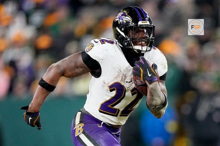 Dec 27, 2025; Green Bay, Wisconsin, USA; Baltimore Ravens running back Derrick Henry (22) runs for a touchdown during the fourth quarter against the Green Bay Packers at Lambeau Field. Credit: Jeff Hanisch-Imagn Images