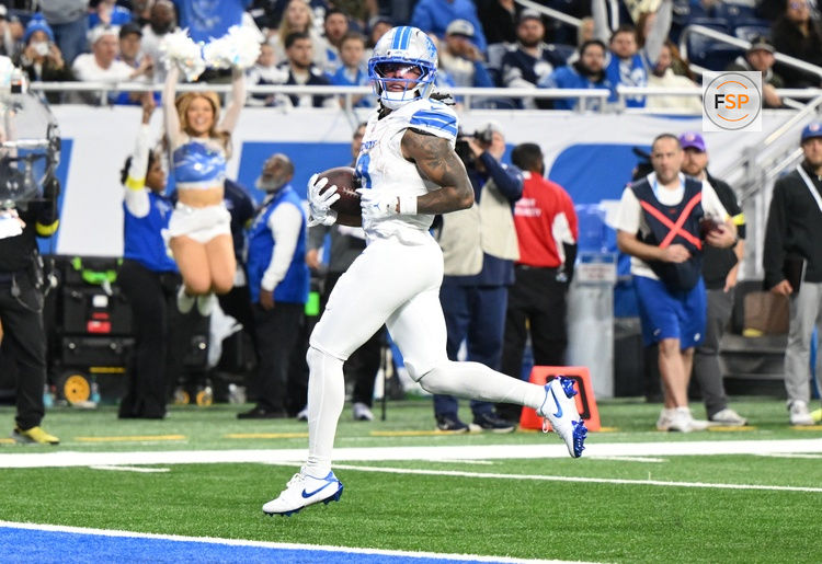 Dec 4, 2025; Detroit, Michigan, USA; Detroit Lions running back Jahmyr Gibbs (0) scores a touchdown during the second half against the Dallas Cowboys at Ford Field. Credit: Lon Horwedel-Imagn Images