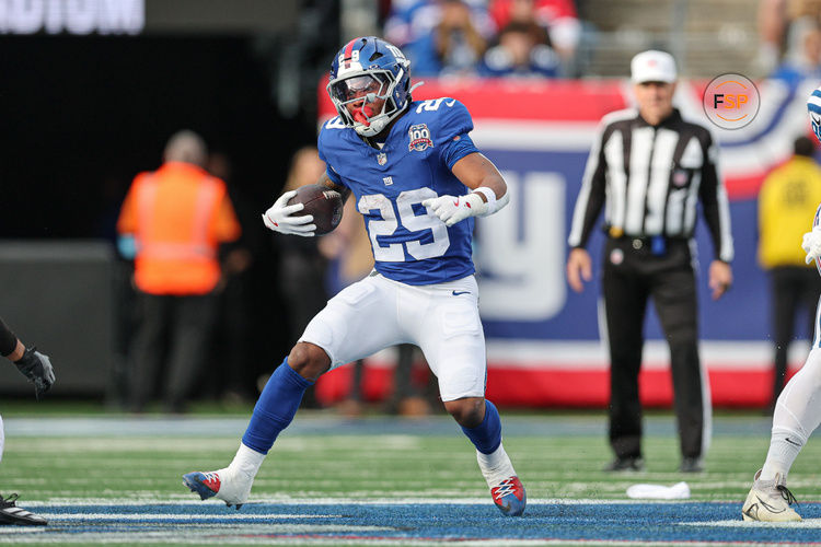 Dec 29, 2024; East Rutherford, New Jersey, USA; New York Giants running back Tyrone Tracy Jr. (29) carries the ball during the first half against the Indianapolis Colts at MetLife Stadium. Credit: Vincent Carchietta-Imagn Images