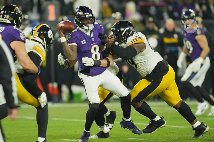 Jan 11, 2025; Baltimore, Maryland, USA; Pittsburgh Steelers defensive tackle Larry Ogunjobi (99) and linebacker Alex Highsmith (56) tackle Baltimore Ravens quarterback Lamar Jackson (8) in the third quarter in an AFC wild card game at M&T Bank Stadium. Credit: Mitch Stringer-Imagn Images