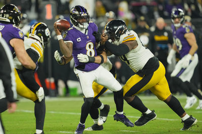 Jan 11, 2025; Baltimore, Maryland, USA; Pittsburgh Steelers defensive tackle Larry Ogunjobi (99) and linebacker Alex Highsmith (56) tackle Baltimore Ravens quarterback Lamar Jackson (8) in the third quarter in an AFC wild card game at M&T Bank Stadium. Mandatory Credit: Mitch Stringer-Imagn Images