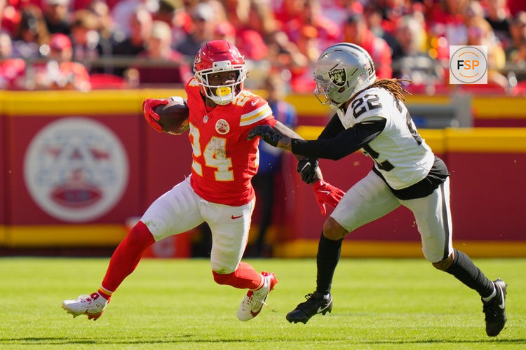 Oct 19, 2025; Kansas City, Missouri, USA; Kansas City Chiefs running back Brashard Smith (24) carries the ball defended by Las Vegas Raiders cornerback Eric Stokes (22) during the fourth quarter of the game at GEHA Field at Arrowhead Stadium. Credit: Jay Biggerstaff-Imagn Images