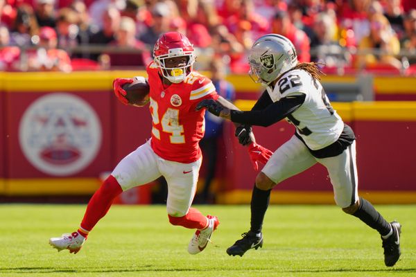 Oct 19, 2025; Kansas City, Missouri, USA; Kansas City Chiefs running back Brashard Smith (24) carries the ball defended by Las Vegas Raiders cornerback Eric Stokes (22) during the fourth quarter of the game at GEHA Field at Arrowhead Stadium. Mandatory Credit: Jay Biggerstaff-Imagn Images