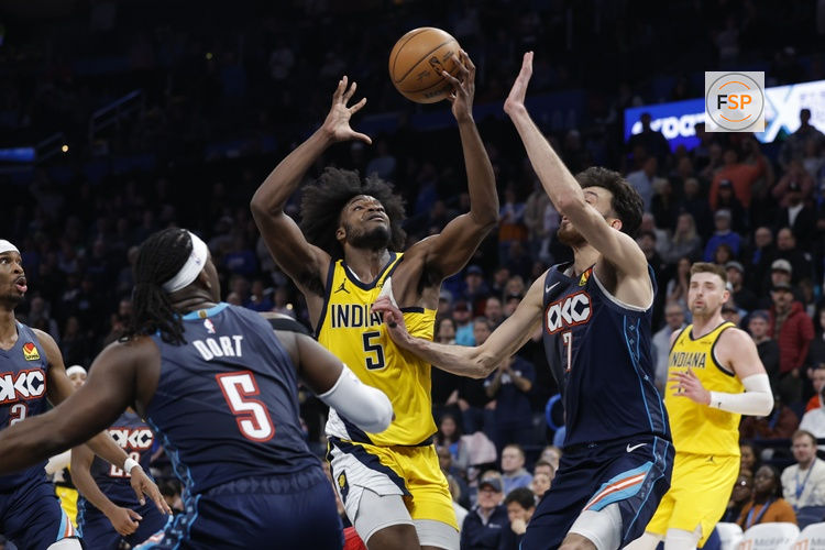 Jan 23, 2026; Oklahoma City, Oklahoma, USA; Indiana Pacers forward Jarace Walker (5) drives to the basket as Oklahoma City Thunder center/forward Chet Holmgren (7) defends during the second half at Paycom Center. Credit: Alonzo Adams-Imagn Images