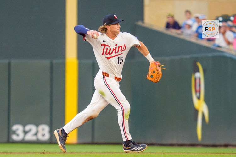 Aug 9, 2025; Minneapolis, Minnesota, USA; Minnesota Twins second baseman Luke Keaschall (15) throws to first base retiring Kansas City Royals shortstop Bobby Witt Jr. (not pictured) in the eighth inning at Target Field. Credit: Matt Blewett-Imagn Images