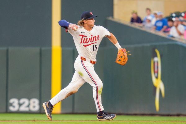 Aug 9, 2025; Minneapolis, Minnesota, USA; Minnesota Twins second baseman Luke Keaschall (15) throws to first base retiring Kansas City Royals shortstop Bobby Witt Jr. (not pictured) in the eighth inning at Target Field. Mandatory Credit: Matt Blewett-Imagn Images