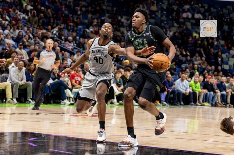 Dec 8, 2025; New Orleans, Louisiana, USA;  New Orleans Pelicans center Derik Queen (22) is fouled by San Antonio Spurs forward Harrison Barnes (40) during the second half at Smoothie King Center. Credit: Stephen Lew-Imagn Images