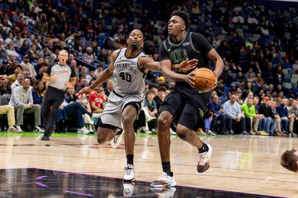 Dec 8, 2025; New Orleans, Louisiana, USA;  New Orleans Pelicans center Derik Queen (22) is fouled by San Antonio Spurs forward Harrison Barnes (40) during the second half at Smoothie King Center. Mandatory Credit: Stephen Lew-Imagn Images