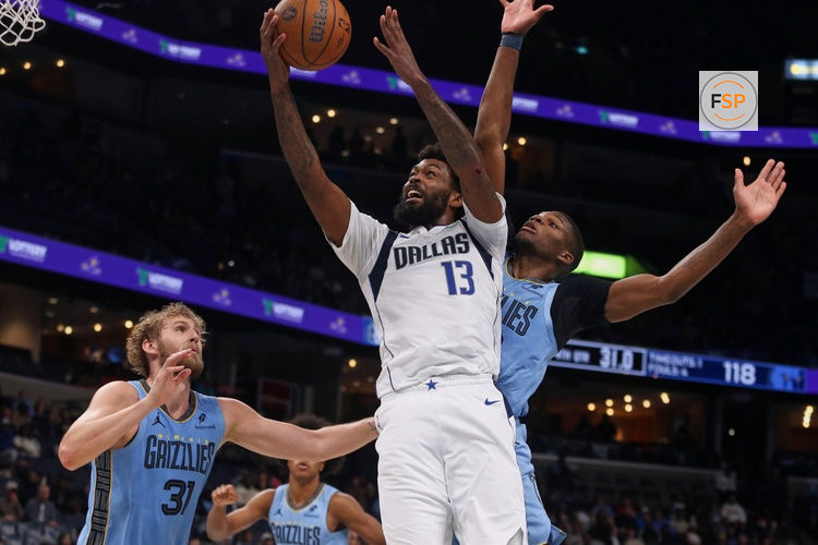 Nov 7, 2025; Memphis, Tennessee, USA; Dallas Mavericks forward Naji Marshall (13) shoots the ball against Memphis Grizzlies center Jock Landale (31) and forward Cedric Coward (23) during the fourth quarter at FedExForum. Credit: Petre Thomas-Imagn Images