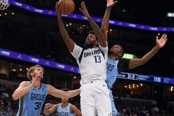 Nov 7, 2025; Memphis, Tennessee, USA; Dallas Mavericks forward Naji Marshall (13) shoots the ball against Memphis Grizzlies center Jock Landale (31) and forward Cedric Coward (23) during the fourth quarter at FedExForum. Mandatory Credit: Petre Thomas-Imagn Images