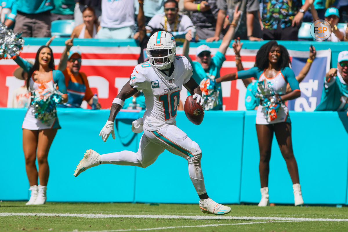 Sep 8, 2024; Miami Gardens, Florida, USA; Miami Dolphins wide receiver Tyreek Hill (10) run with the football for a touchdown against the Jacksonville Jaguars during the third quarter at Hard Rock Stadium. Credit: Sam Navarro-Imagn Images