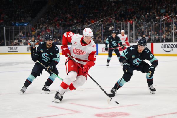 Dec 6, 2025; Seattle, Washington, USA; Detroit Red Wings left wing Elmer Soderblom (85) advances the puck while defended by Seattle Kraken defenseman Ryker Evans (41) during the third period at Climate Pledge Arena. Mandatory Credit: Steven Bisig-Imagn Images