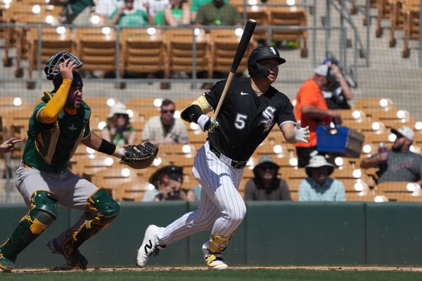 Mar 17, 2026; Phoenix, Arizona, USA; Chicago White Sox third baseman Munetaka Murakami (5) hits against the Athletics in the first inning at Camelback Ranch-Glendale. Mandatory Credit: Rick Scuteri-Imagn Images