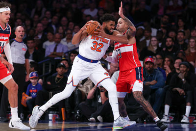 Oct 9, 2024; New York, New York, USA; New York Knicks center Karl-Anthony Towns (32) drives to the basket against Washington Wizards forward Kyle Kuzma (33) during the first quarter at Madison Square Garden. Mandatory Credit: Vincent Carchietta-Imagn Images