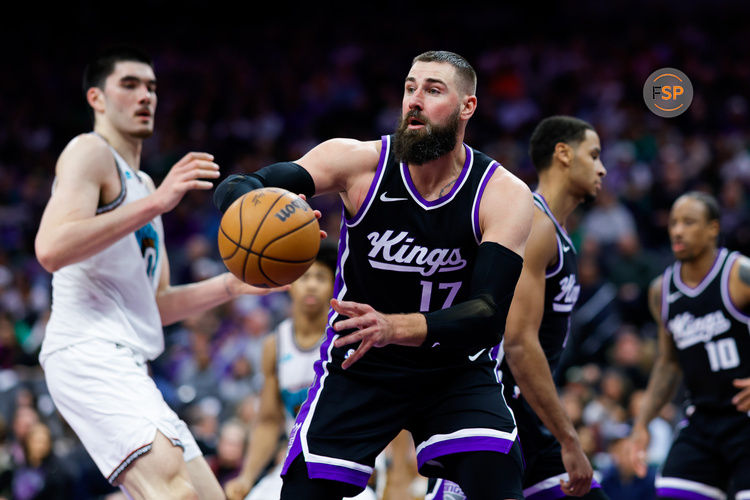 Mar 17, 2025; Sacramento, California, USA; Sacramento Kings center Jonas Valanciunas (17) passes the ball against Memphis Grizzlies center Zach Edey (14) during the fourth quarter at Golden 1 Center. Credit: Sergio Estrada-Imagn Images