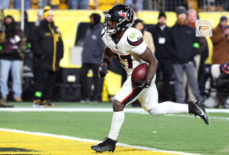 Jan 12, 2026; Pittsburgh, PA, USA; Houston Texans running back Woody Marks (27) scores a touchdown during the second half of an AFC Wild Card Round game against the Pittsburgh Steelers at Acrisure Stadium. Credit: Charles LeClaire-Imagn Images