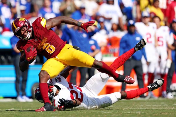 Sep 15, 2024; Landover, Maryland, USA; Washington Commanders running back Brian Robinson Jr. (8) runs the ball against New York Giants safety Jason Pinnock (27) during the third quarter at Commanders Field. Mandatory Credit: Peter Casey-Imagn Images