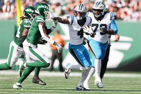 Oct 19, 2025; East Rutherford, New Jersey, USA; Carolina Panthers wide receiver Tetairoa McMillan (4) stiff arms New York Jets cornerback Sauce Gardner (1) in the second quarter at MetLife Stadium. Mandatory Credit: Vincent Carchietta-Imagn Images