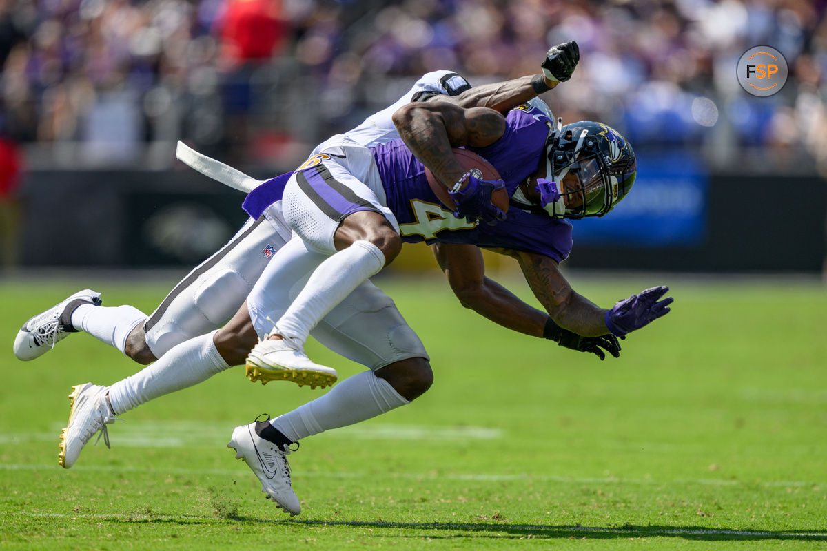 Sep 15, 2024; Baltimore, Maryland, USA; Baltimore Ravens wide receiver Zay Flowers (4) is tackled by Las Vegas Raiders cornerback Jakorian Bennett (0) during the first half at M&T Bank Stadium. Credit: Reggie Hildred-Imagn Images