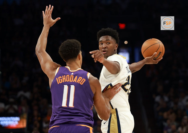 Nov 10, 2025; Phoenix, Arizona, USA; New Orleans Pelicans center Derik Queen (22) against Phoenix Suns forward Oso Ighodaro (11) in the first half at the Mortgage Matchup Center. Credit: Mark J. Rebilas-Imagn Images