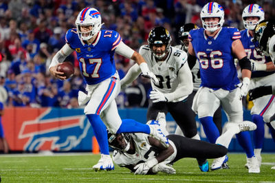 Sep 23, 2024; Orchard Park, New York, USA; Buffalo Bills quarterback Josh Allen (17) breaks a tackle by Jacksonville Jaguars linebacker Devin Lloyd (33) during the first half at Highmark Stadium. Mandatory Credit: Gregory Fisher-Imagn Images