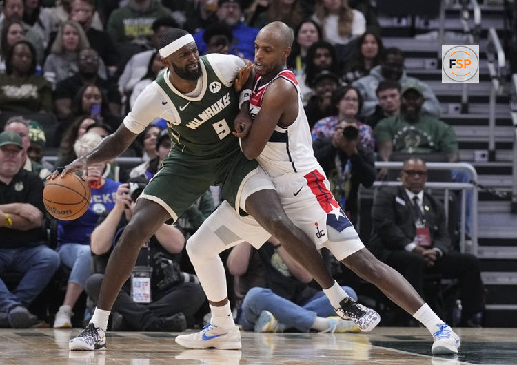 Oct 22, 2025; Milwaukee, Wisconsin, USA; Milwaukee Bucks forward Bobby Portis (9) and Washington Wizards forward Khris Middleton (22) battle against each other in the second half at Fiserv Forum. Credit: Michael McLoone-Imagn Images