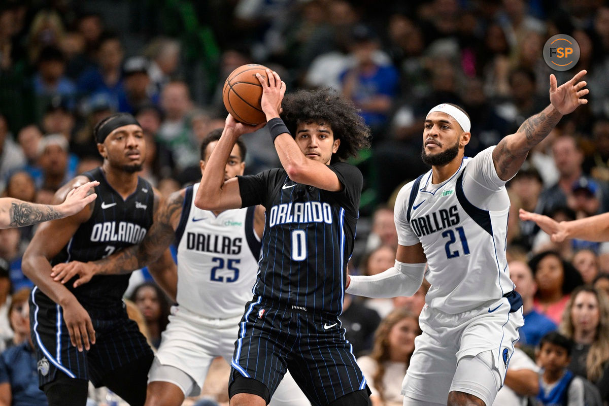 Nov 3, 2024; Dallas, Texas, USA; Orlando Magic guard Anthony Black (0) looks to move the ball past Dallas Mavericks forward P.J. Washington (25) and center Daniel Gafford (21) during the second quarter at the American Airlines Center. Credit: Jerome Miron-Imagn Images