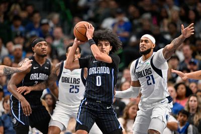 Nov 3, 2024; Dallas, Texas, USA; Orlando Magic guard Anthony Black (0) looks to move the ball past Dallas Mavericks forward P.J. Washington (25) and center Daniel Gafford (21) during the second quarter at the American Airlines Center. Mandatory Credit: Jerome Miron-Imagn Images