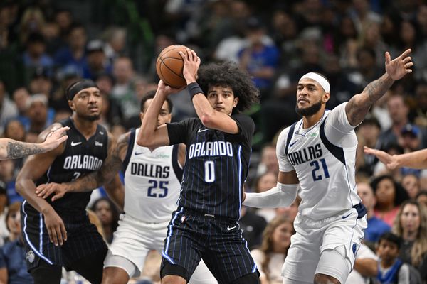 Nov 3, 2024; Dallas, Texas, USA; Orlando Magic guard Anthony Black (0) looks to move the ball past Dallas Mavericks forward P.J. Washington (25) and center Daniel Gafford (21) during the second quarter at the American Airlines Center. Mandatory Credit: Jerome Miron-Imagn Images