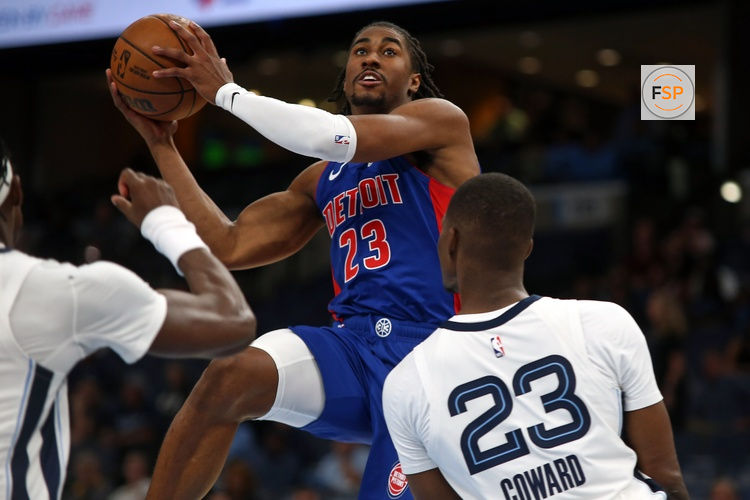 Oct 6, 2025; Memphis, Tennessee, USA; Detroit Pistons guard Jaden Ivey (23) drives to the basket as Memphis Grizzlies forward Cedric Coward (23) defends during the second quarter at FedExForum. Credit: Petre Thomas-Imagn Images