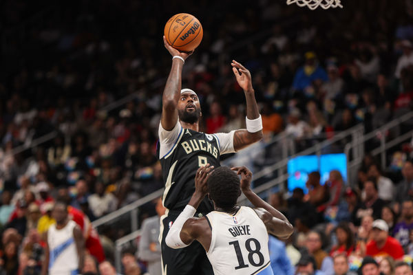 Feb 7, 2025; Atlanta, Georgia, USA; Milwaukee Bucks forward Bobby Portis (9) shoots over Atlanta Hawks forward Mouhamed Gueye (18) in the second quarter at State Farm Arena. Mandatory Credit: Brett Davis-Imagn Images