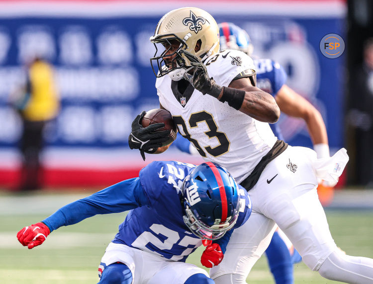 Dec 8, 2024; East Rutherford, New Jersey, USA; New Orleans Saints tight end Juwan Johnson (83) is tackled by New York Giants safety Jason Pinnock (27) during the first half at MetLife Stadium. Credit: Vincent Carchietta-Imagn Images