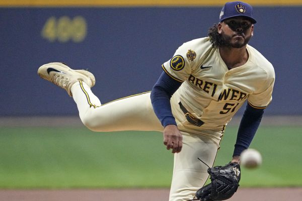 Oct 14, 2025; Milwaukee, Wisconsin, USA; Milwaukee Brewers pitcher Freddy Peralta (51) throws pitch against the Los Angeles Dodgers in the first inning during game two of the NLCS round for the 2025 MLB playoffs at American Family Field. Mandatory Credit: Michael McLoone-Imagn Images