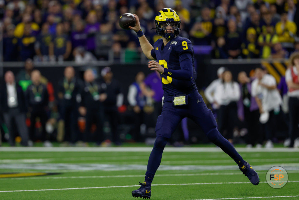 HOUSTON, TX - JANUARY 08: Michigan Wolverines quarterback J.J. McCarthy (9) rolls out for a pass during the CFP National Championship game Michigan Wolverines and Washington Huskies on January 8, 2024, at NRG Stadium in Houston, Texas. (Photo by David Buono/Icon Sportswire)