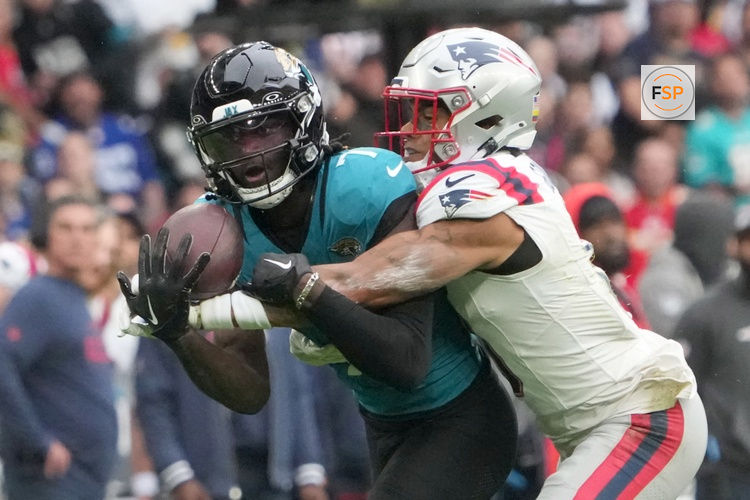 Oct 20, 2024; London, United Kingdom; Jacksonville Jaguars wide receiver Brian Thomas Jr. (7) catches a 58-yard pass against New England Patriots cornerback Christian Gonzalez (0) in the first half of an NFL International Series game at Wembley Stadium. Credit: Kirby Lee-Imagn Images