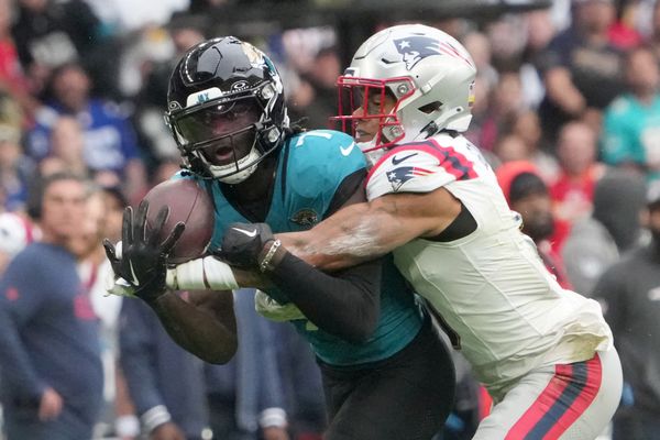 Oct 20, 2024; London, United Kingdom; Jacksonville Jaguars wide receiver Brian Thomas Jr. (7) catches a 58-yard pass against New England Patriots cornerback Christian Gonzalez (0) in the first half of an NFL International Series game at Wembley Stadium. Mandatory Credit: Kirby Lee-Imagn Images