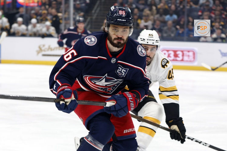 Apr 12, 2026; Columbus, Ohio, USA; Columbus Blue Jackets right wing Kirill Marchenko (86) and Boston Bruins defenseman Jonathan Aspirot (45) skate after a loose puck during the first period at Nationwide Arena. Credit: Russell LaBounty-Imagn Images