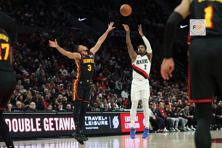 Jan 15, 2026; Portland, Oregon, USA;  Portland Trail Blazers guard Caleb Love (2) shoots the ball over Atlanta Hawks guard CJ McCollum (3) during the first half at Moda Center. Credit: Jaime Valdez-Imagn Images