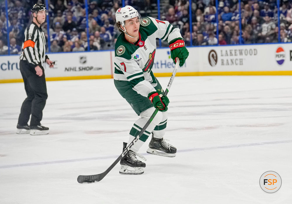 TAMPA, FL - JANUARY 18: Minnesota Wild defenseman Brock Faber (7) shoots the puck during the NHL Hockey match between the Tampa Bay Lightning and Minnesota Wild on January 18th, 2024 at Amalie Arena in Tampa, FL. (Photo by Andrew Bershaw/Icon Sportswire)