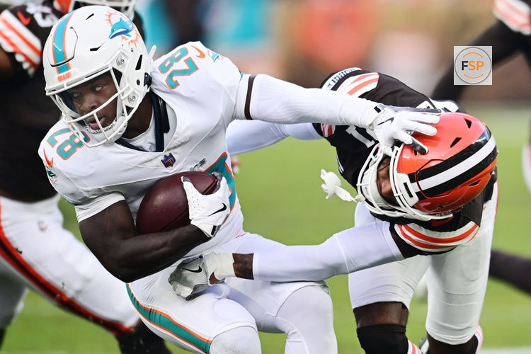 Dec 29, 2024; Cleveland, Ohio, USA; Cleveland Browns cornerback Denzel Ward (21) tackles Miami Dolphins running back De'Von Achane (28) during the first half at Huntington Bank Field. Credit: Ken Blaze-Imagn Images