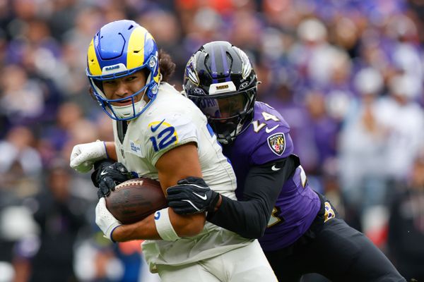 Oct 12, 2025; Baltimore, Maryland, USA; Baltimore Ravens safety Malaki Starks (24) tackles Los Angeles Rams wide receiver Puka Nacua (12) during the second quarter of the game at M&T Bank Stadium. Mandatory Credit: Peter Casey-Imagn Images
