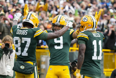 Oct 13, 2024; Green Bay, Wisconsin, USA;  Green Bay Packers wide receiver Romeo Doubs (87) celebrates with wide receivers Christian Watson (9) and Jayden Reed (11) after scoring a touchdown during the third quarter against the Arizona Cardinals at Lambeau Field. Mandatory Credit: Jeff Hanisch-Imagn Images