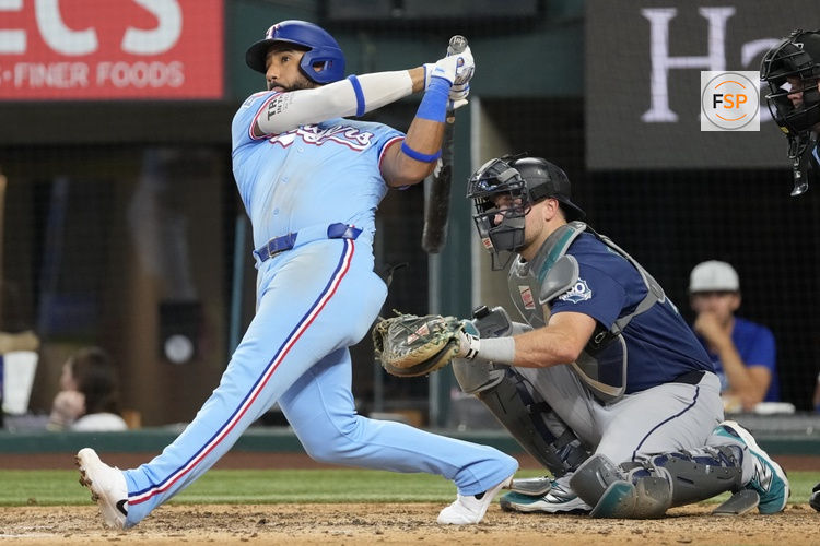 Jul 26, 2026; Arlington, Texas, USA; Texas Rangers shortstop Ezequiel Duran (20) follows through for a solo home run against the Seattle Mariners during the eighth inning at Globe Life Field. Credit: Jim Cowsert-Imagn Images