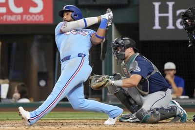 Jul 26, 2026; Arlington, Texas, USA; Texas Rangers shortstop Ezequiel Duran (20) follows through for a solo home run against the Seattle Mariners during the eighth inning at Globe Life Field. Mandatory Credit: Jim Cowsert-Imagn Images