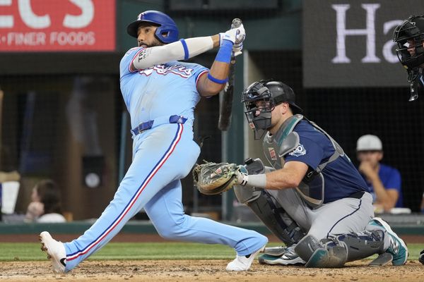 Jul 26, 2026; Arlington, Texas, USA; Texas Rangers shortstop Ezequiel Duran (20) follows through for a solo home run against the Seattle Mariners during the eighth inning at Globe Life Field. Mandatory Credit: Jim Cowsert-Imagn Images