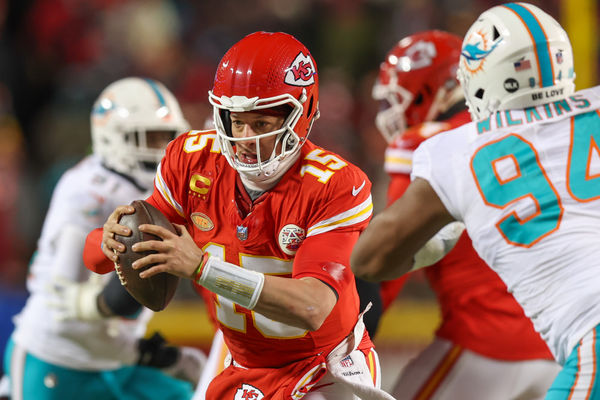 KANSAS CITY, MO - JANUARY 13: Kansas City Chiefs quarterback Patrick Mahomes (15) breaks away from Miami Dolphins defensive tackle Christian Wilkins (94) on a scramble in the third quarter of an AFC Wild Card playoff game between the Miami Dolphins and Kansas City Chiefs on Jan 13, 2024 at GEHA Field at Arrowhead Stadium in Kansas City, MO. (Photo by Scott Winters/Icon Sportswire)