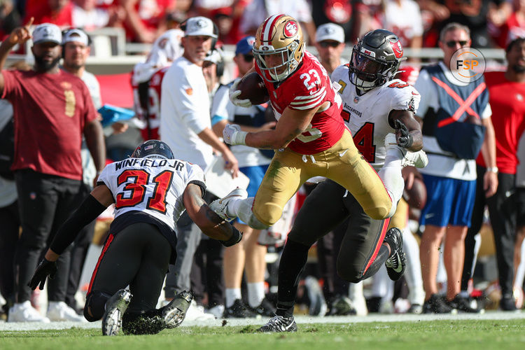 Nov 10, 2024; Tampa, Florida, USA; San Francisco 49ers running back Christian McCaffrey (23) is brought down by Tampa Bay Buccaneers safety Antoine Winfield Jr. (31) and linebacker Lavonte David (54) in the fourth quarter at Raymond James Stadium. Credit: Nathan Ray Seebeck-Imagn Images
