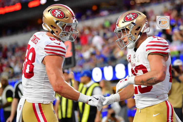 Oct 2, 2025; Inglewood, California, USA;  San Francisco 49ers running back Christian McCaffrey (23) reacts with  tight end Jake Tonges (88) after scoring a touchdown during the first half at SoFi Stadium. Credit: Gary A. Vasquez-Imagn Images