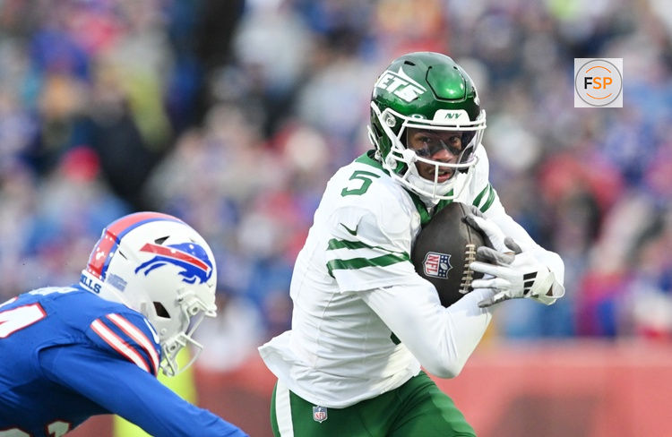 Dec 29, 2024; Orchard Park, New York, USA; New York Jets wide receiver Garrett Wilson (5) tries to get past Buffalo Bills safety Cole Bishop (24) after making a catch in the second quarter at Highmark Stadium. Credit: Mark Konezny-Imagn Images