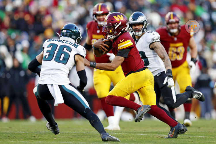 Dec 22, 2024; Landover, Maryland, USA; Washington Commanders quarterback Jayden Daniels (5) runs the ball during the fourth quarter against the Philadelphia Eagles at Northwest Stadium. Credit: Peter Casey-Imagn Images